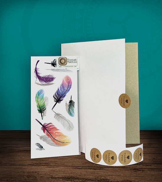 Tintak temporary tattoo with feather design, with its hard board packaging.