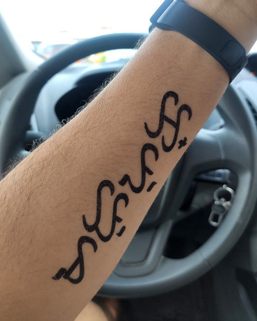 Baybayin Text temporary tattoo on a man's arm.