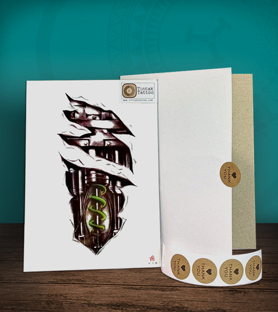 Tintak temporary tattoo sticker with biomech design, with its hard board packaging.