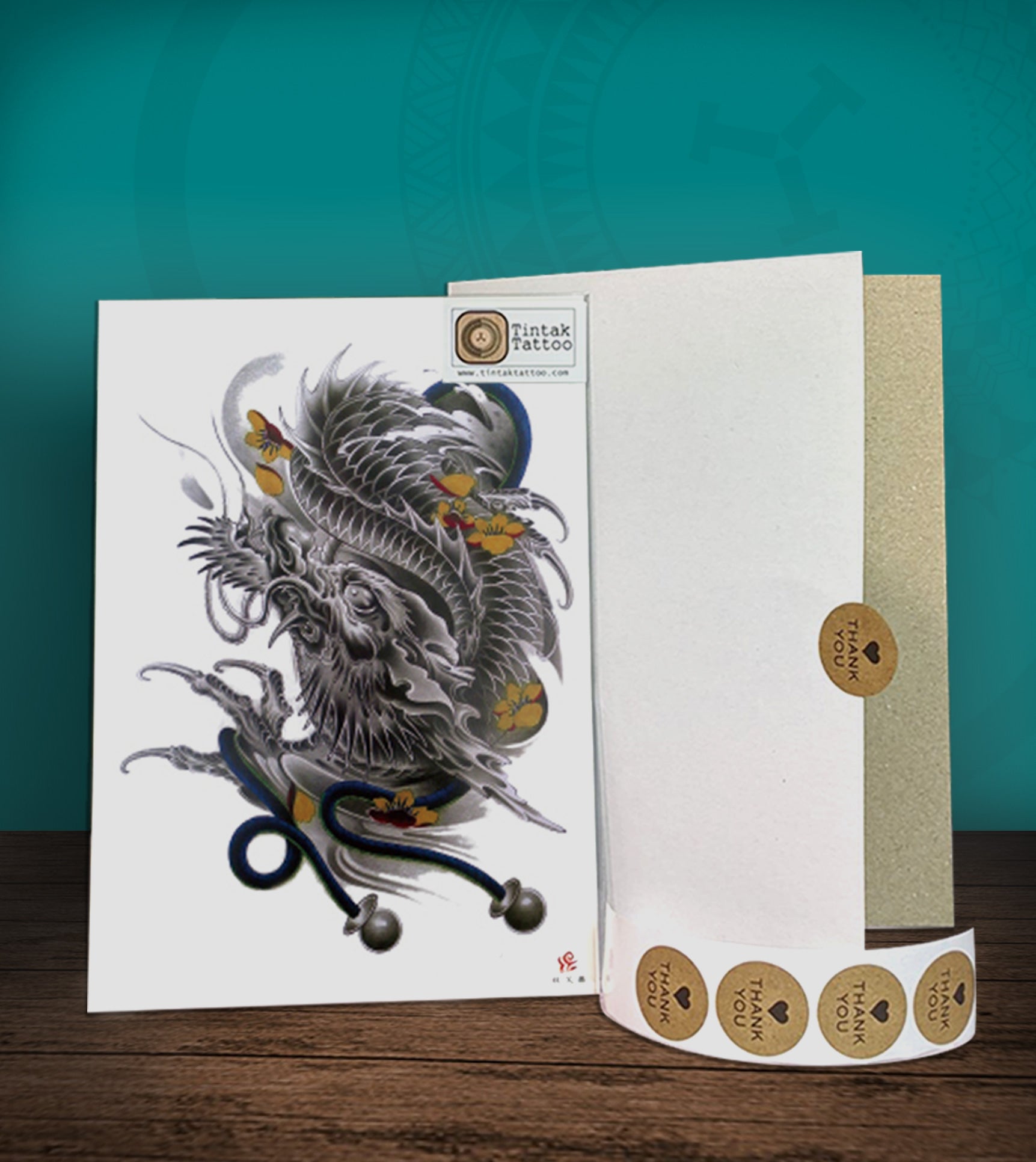 Tintak temporary tattoo sticker with dragon design, with its hard board packaging.