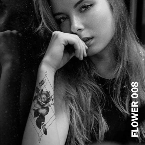 Temporary tattoo sticker on a woman's arm with black and gray rose flower design with geometric lines.