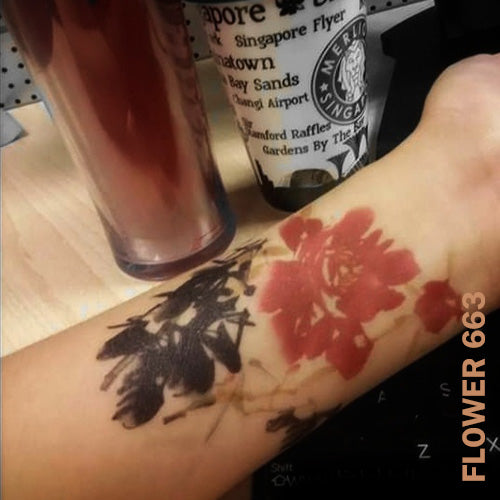 Woman's arm with flower temporary tattoo sticker.