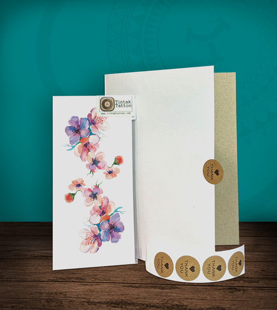 Tintak temporary tattoo sticker with flower design, with its hard board packaging.