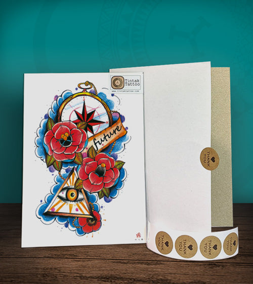 Tintak temporary tattoo sticker with the eye, roses, and compass design, with its hard board packaging.
