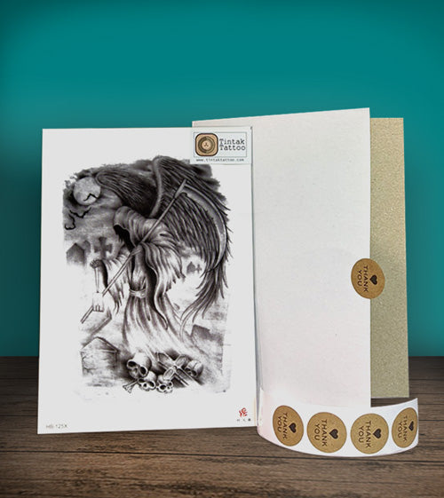 Tintak Temporary Tatoo sticker with grim reaper design, placed on a wooden table beside its packaging.