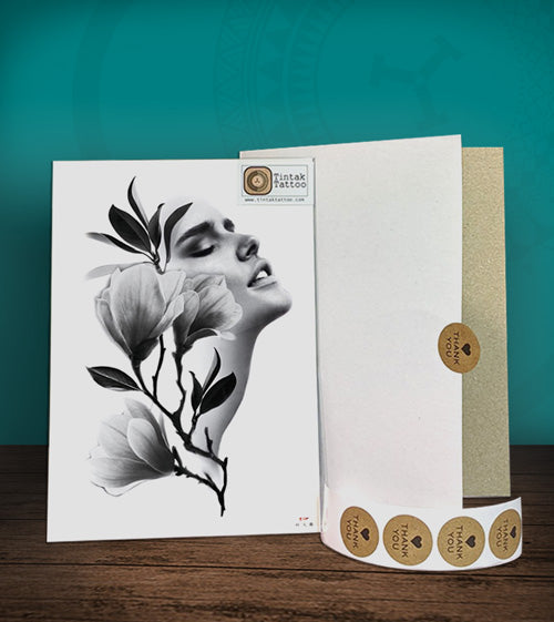 Tintak temporary tattoo sticker with a woman's face and flower design, with its hard board packaging.