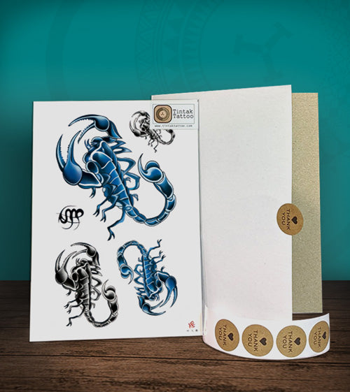 Tintak temporary tattoo sticker with black and blue scorpions design, with its hard board packaging.