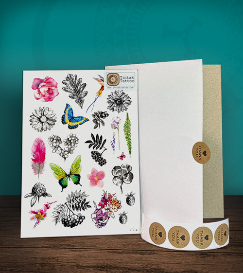 Tintak temporary tattoo with butterfly and flower designs, with its hard board packaging.