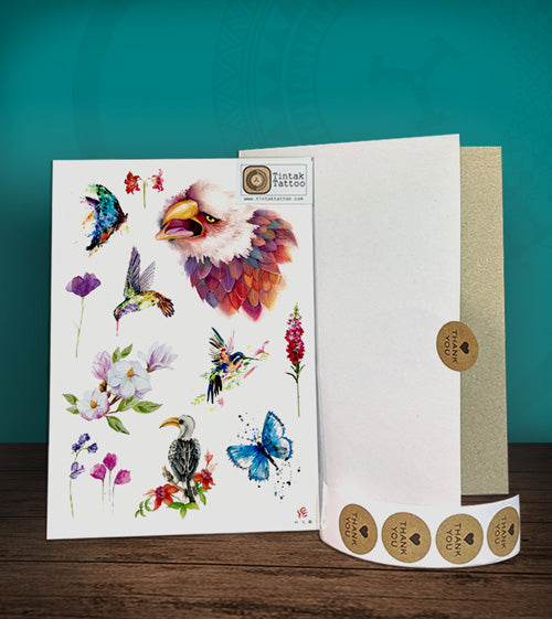 Tintak temporary tattoo with bird and flower designs, with its hard board packaging.