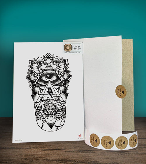 Tintak temporary tattoo sticker with the eye of providence design beside its packaging.