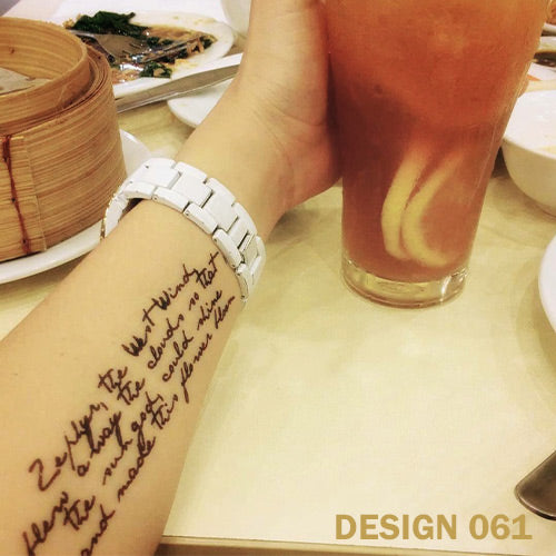 Written words temporary tattoo on woman's arm.