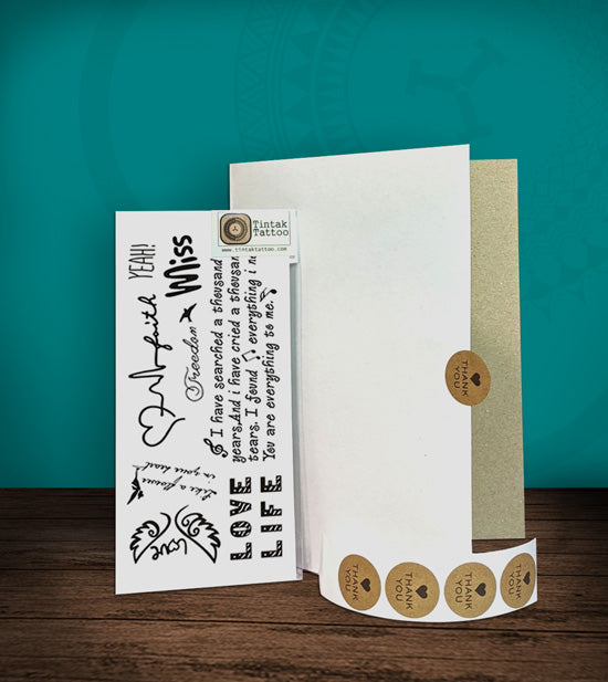 Tintak temporary tattoo with written words design, with its hard board packaging.