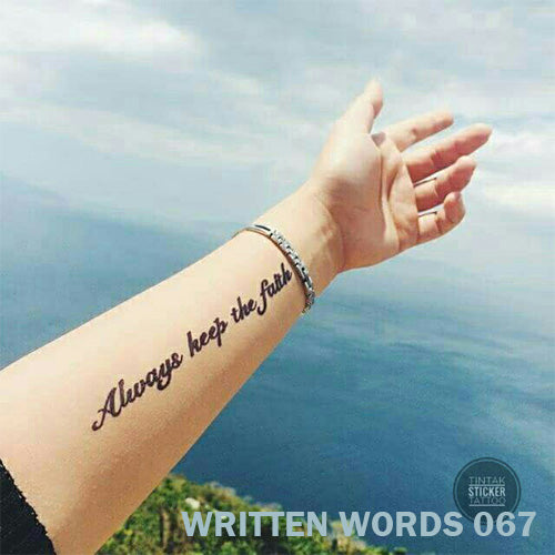 "Always keep the faith" temporary tattoo placed on a woman's arm.