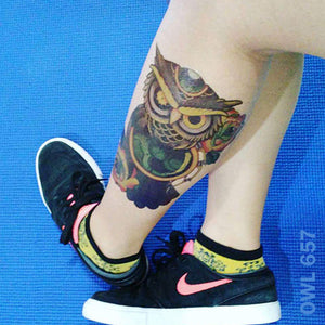 Owl temporary tattoo on woman's leg.
