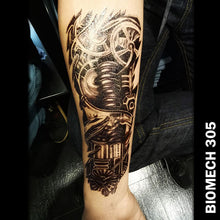 Load image into Gallery viewer, black and gray temporary tattoo sticker on men&#39;s arm with biomechanical design with gears and other machine parts