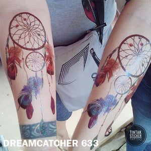 Two arms from a man and a woman showing their dream catcher temporary tattoo sticker.