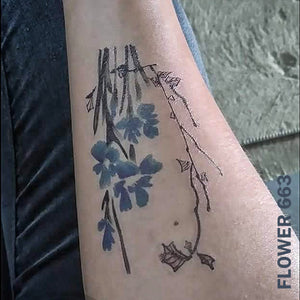 Woman's arm with flower temporary tattoo sticker.