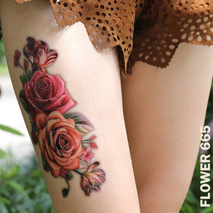 Pink rose flower temporary tattoo sticker design on woman's leg.