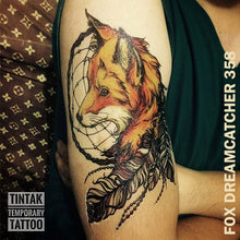 Load image into Gallery viewer, Man&#39;s upper arm with a fox dream catcher temporary tattoo sticker.