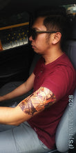 Load image into Gallery viewer, A man inside the car with a timeless half sleeve temporary tattoo.