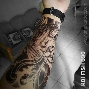 Koi Fish temporary tattoo sticker on man's arm.