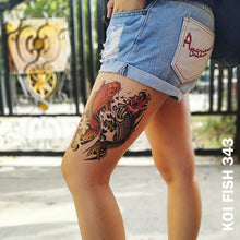 Load image into Gallery viewer, Woman&#39;s leg in her shorts and two colored koi fish temporary tattoo sticker.