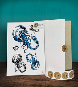 Tintak temporary tattoo sticker with black and blue scorpions design, with its hard board packaging.