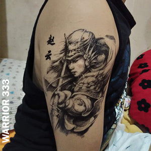 Warrior temporary tattoo sticker placed on man's upper arm.