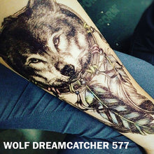 Load image into Gallery viewer, Temporary tattoo sticker placed on an arm with black and gray wolf dream catcher design.