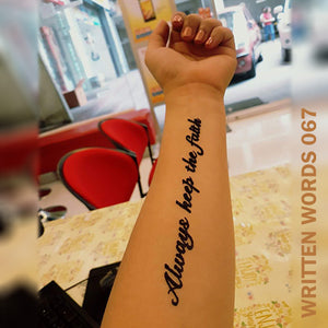 "Always keep the faith" temporary tattoo placed on a woman's arm.